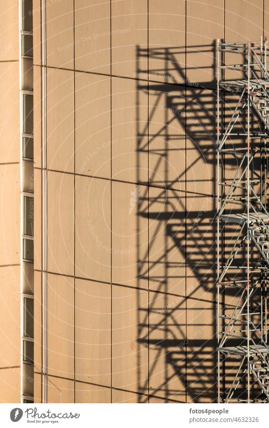 Scaffolding on skyscraper Shadow graphically Pattern squares lines staircases height Brown Window Abstract Structures and shapes Facade Minimalistic Redecorate
