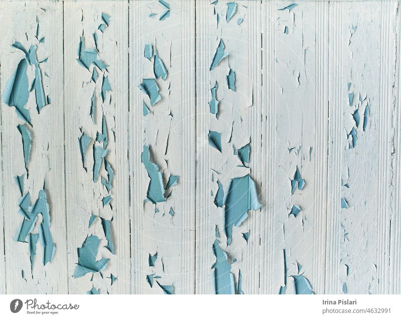 Old shabby wooden planks with cracked color paint, background. light blue abstract aged ancient antique art backdrop board closeup colorful crumpled decorative