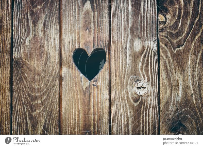 Wooden door with heart shape hole. Wood texture background wood plank rustic wooden timber rough old pattern dark brown grain grunge grungy hardwood material