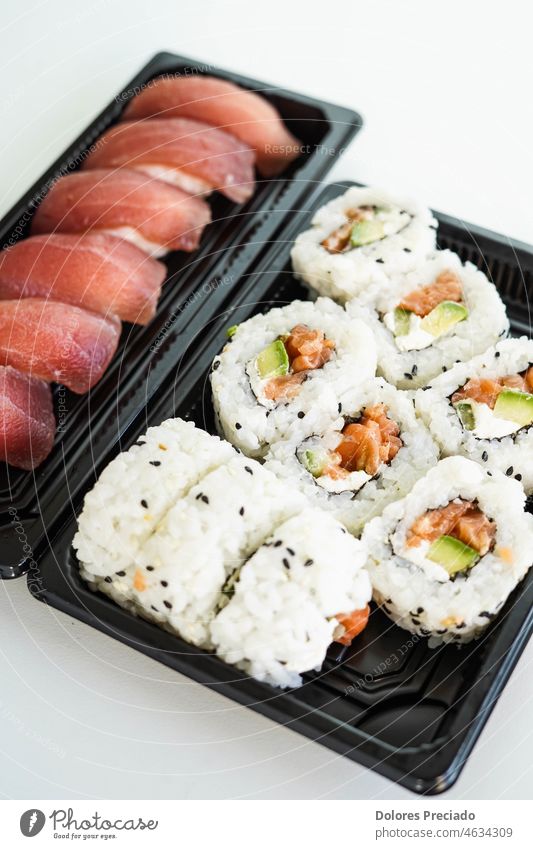 A tray with assorted pieces of sushi. California roll. asia asian background bluefin tuna cooking cuisine delicacy delicious diet dinner eastern eat ethnic