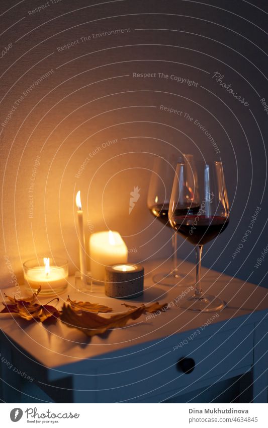 Candlelight date - two glasses of red wine with candles on the table romantic candlelight romance autumn winter warm cozy alcohol drink white restaurant