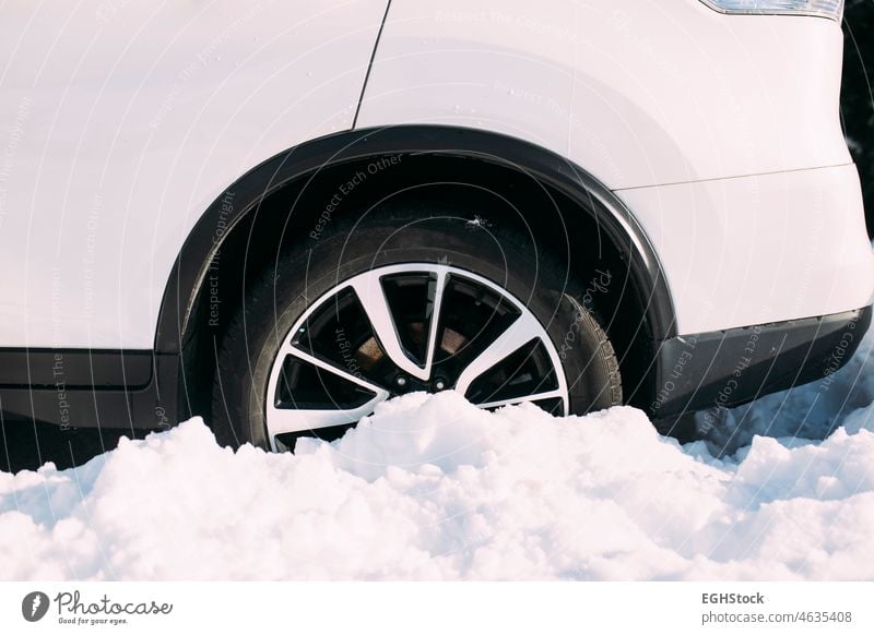 Car with wheel stuck in snow after heavy snowfall assistance auto automobile automotive blizzard car care climate cold condition danger dangerous drive driver