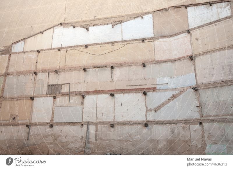 a wall next to a destroyed building can still be seen where the rooms were, in logroño, spain. abstract architecture backdrop background brick brown concrete