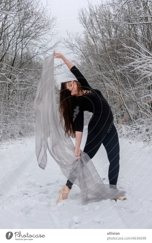 Young woman in black ballet suit plays in snowy forest with a bright cloth Dancer Winter Forest Ballet Grace Girls Performance White Ballet Shoe Ballet Dancer