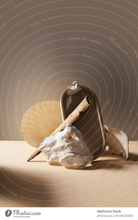 Mirror with wooden stick and stone seashell mirror material still life composition style texture studio glass creative modern table surface light different form