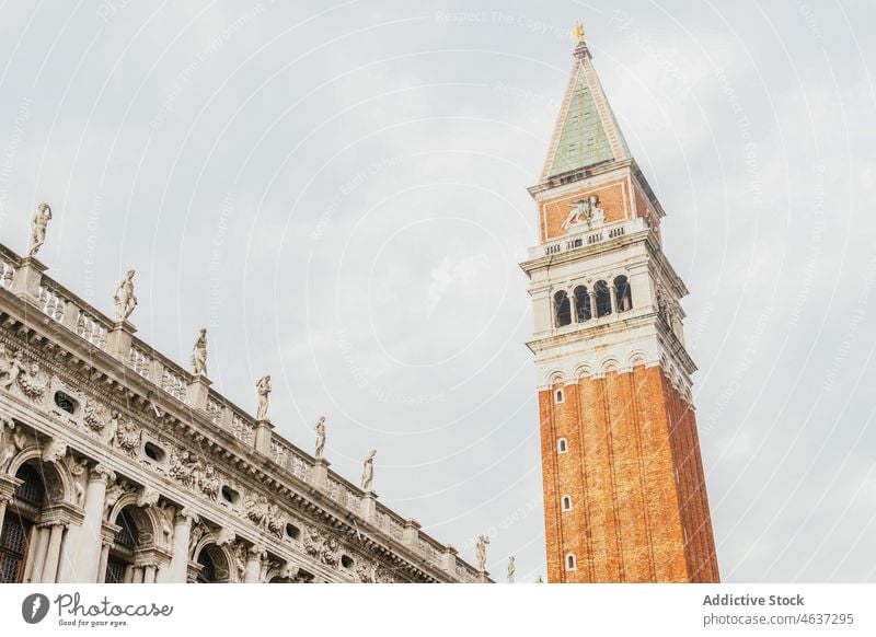Facade of St Marks Campanile with spire against cloudy sky campanile bell tower basilica architecture historic heritage landmark catholic sightseeing religion