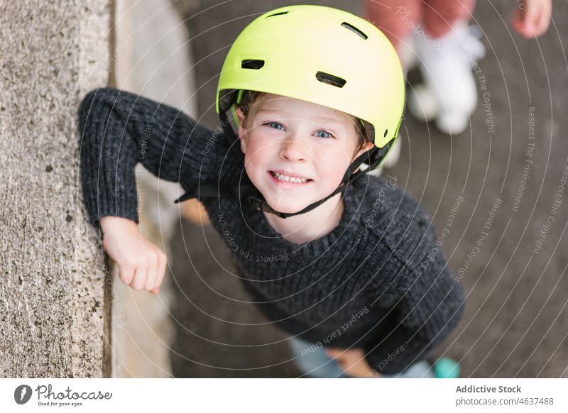Cute boy in helmet near border kid road hobby smile childhood street leisure spend time happy activity barrier practice summer path recreation casual cheerful