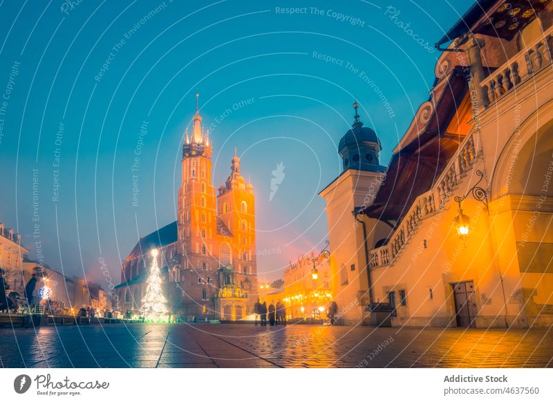 Square of Krakow in evening time square building medieval tower architecture historic city culture church glow illuminate streetlight religion pavement famous