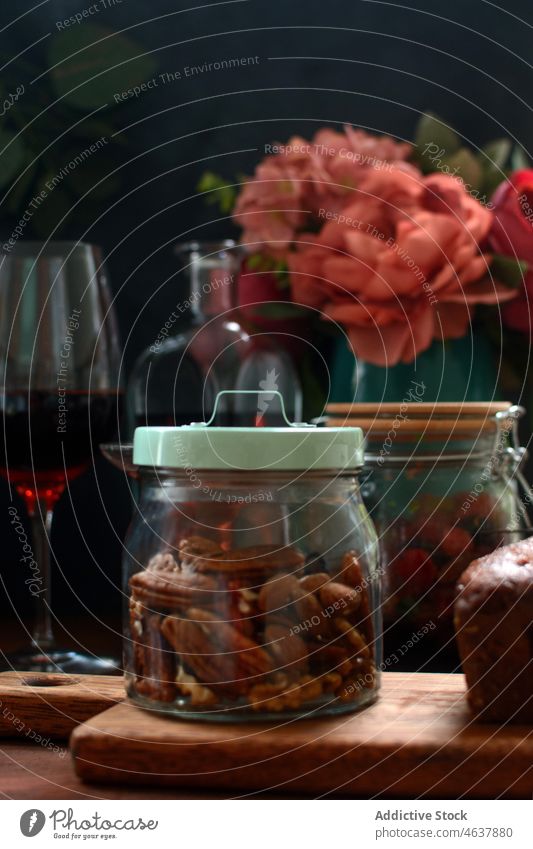 Glass jar with pecan nuts almond alcohol flower product kitchen organic wine glass table bloom chopping board cutting board delicious wooden ingredient tasty