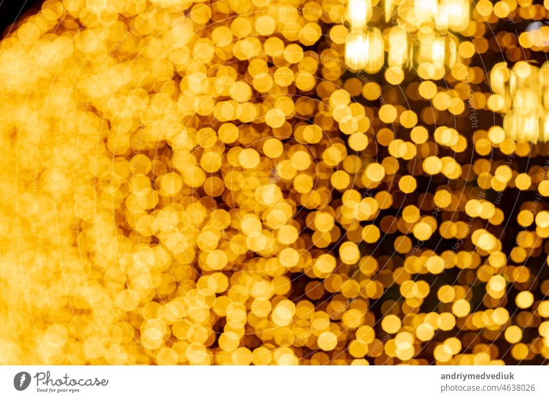 Abstract circular bokeh background of Christmaslight. bokeh from garlands. background for screensaver. Defocused lights. Blurred bokeh with yellow color lights.
