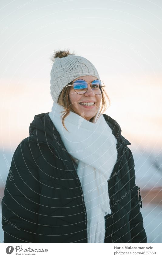 happy woman portrait with hat and glasses smiling outdoors in snow adult beautiful caucasian cold enjoy explore female fun girl happiness leisure lifestyle