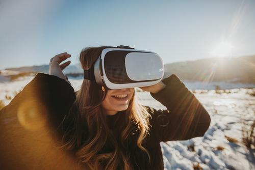 vr goggles outdoors in snow with woman smiling and enjoying the experience adult attractive beautiful beauty caucasian explore face fashion female fun future