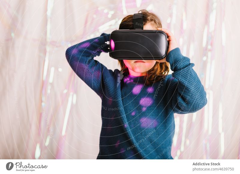 Girl exploring cyberspace in VR glasses child virtual reality explore girl experience vr goggles kid headset neon gadget device innovation digital futuristic