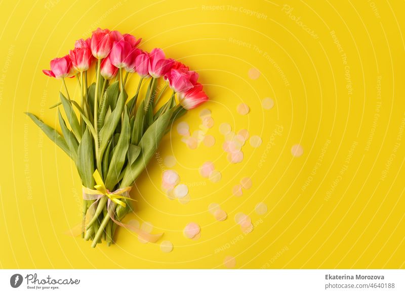 Pink colorful Holiday banner. Bouquet of pink tulips on yellow background. Mother's day, Valentines Day, Birthday, Wedding celebration concept. Hello Spring, Copy space, top view, greeting card banner