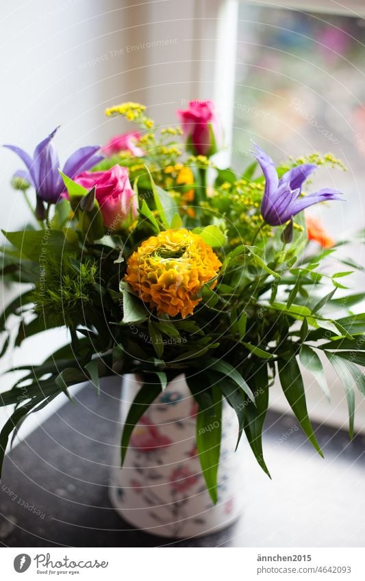 a colorful bouquet of flowers stands in a vase on a dark windowsill Spring Flower Blossom Nature Yellow Pink pink Ostrich Bouquet Interior shot Colour photo