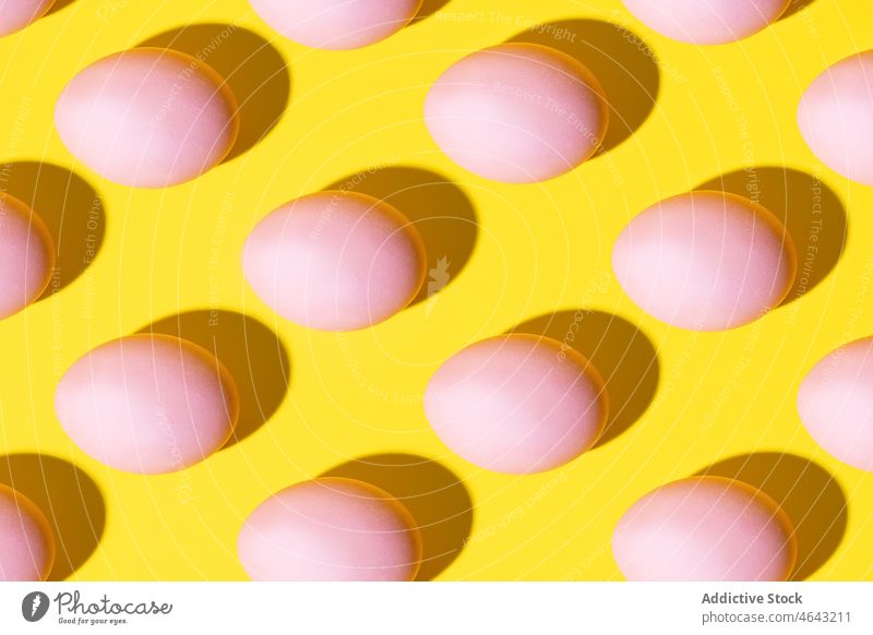 Pink eggs on a yellow background group leader leadership medicine three-dimensional abstract illustration isolated many pill concept design pattern texture food