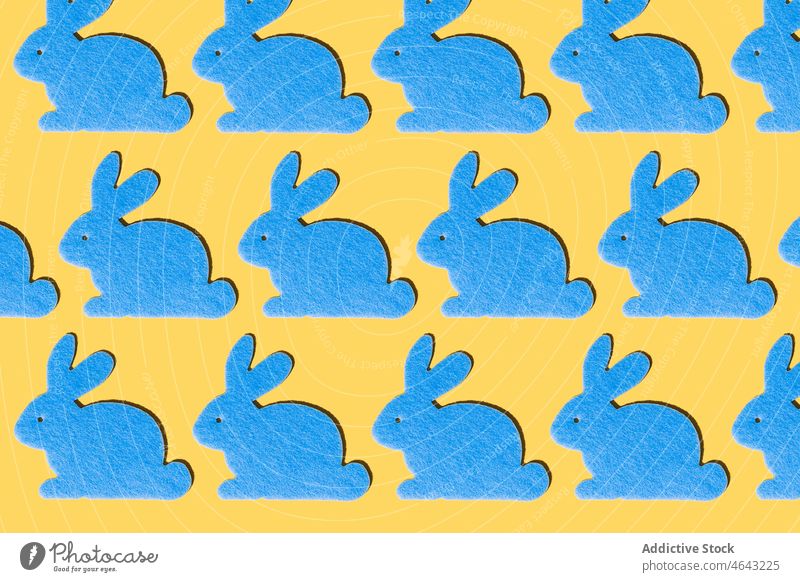 Blue rabbits pattern on a yellow background blue easter design art april celebration spring kids wallpaper bunny cartoon colored gift happy white animal