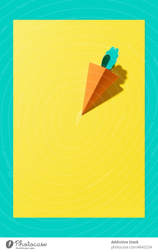 Cardboard carrot on a yellow background in daylight food green healthy vegetarian design leaf nature beautiful fresh white concept nutrition orange vegan ripe