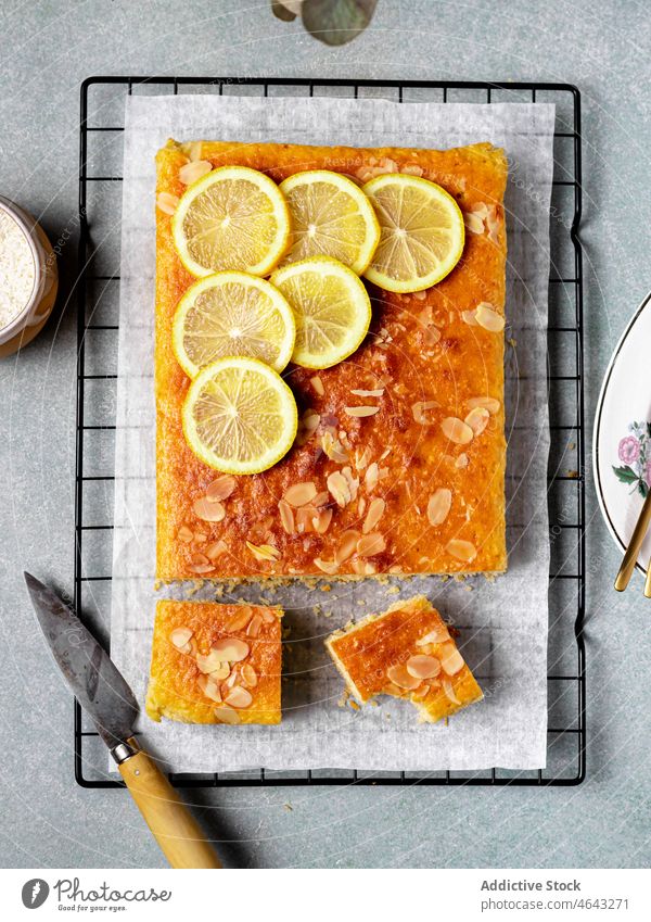 Square slice of tasty homemade lemon cake rack baked dessert sweet citrus treat delicious culinary yummy fruit sour kitchen table cuisine fresh piece food