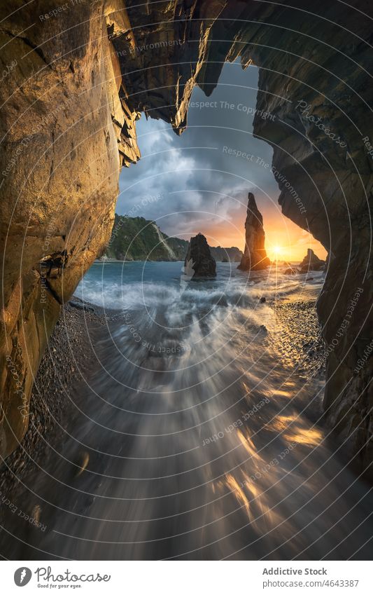 Rocky formations in flowing sea rock cliff water nature stone mountain sunset rocky cave sundown sunrise seawater asturias spain rough cloudy playa del silencio