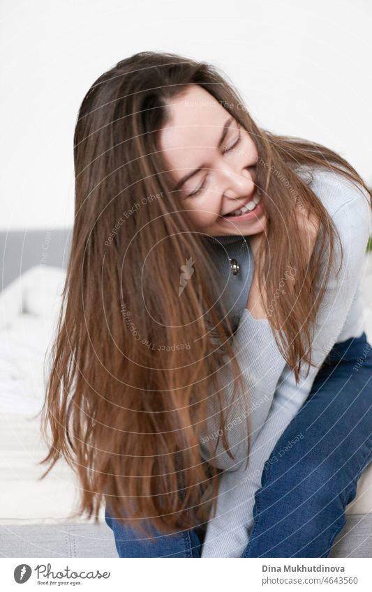 happy young millennial woman in casual clothes laughing and smiling person indoor fun adult lifestyle female friendship happiness home interior photography