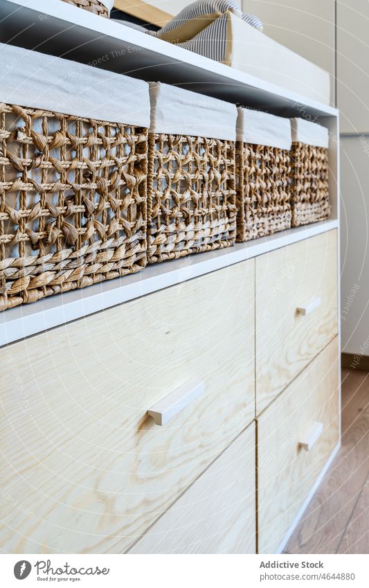 Wicker baskets on wooden drawers rattan storage room wicker design style container apartment home residential flat many element estate set detail collection