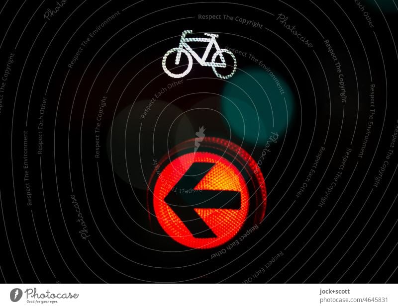 Signal for bike lights red Traffic light Bicycle traffic light Mobility Road sign Pictogram Illuminate Red Berlin Dark Design Symbols and metaphors Left Arrow