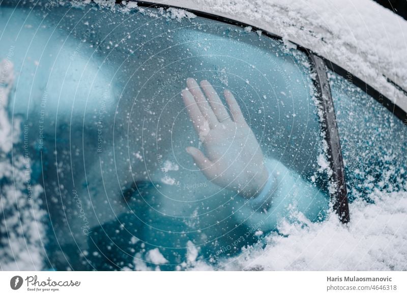 hand on frozen glass in the car background cold cold day frosted misted nature snow surface temperature transparent unfreezing wet white window winter