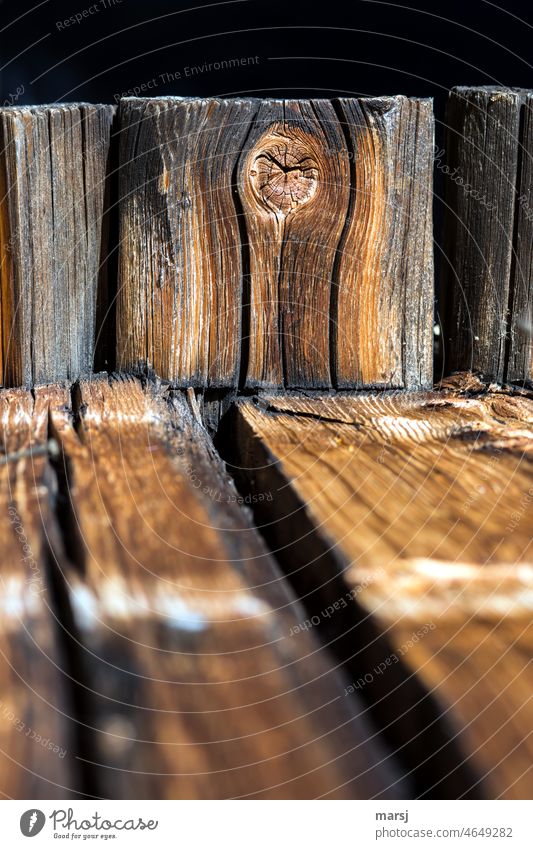 Knothole in logs of an alpine hut. Wood grain Patina Colour photo Brown Structures and shapes Abstract Old Weathered Detail naturally Uniqueness Authentic