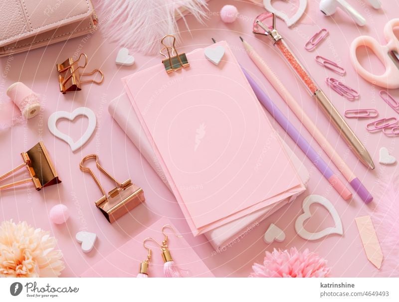 Pink paper card with clip, school girly accessories and hearts on pastel pink close up, mockup education valentine stationery love romantic message feminine
