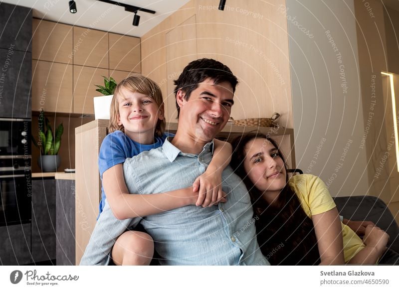 Happy family. Dad with children son and daughter at home in the kitchen laughing and hugging. love happy father mother kids mom dad smile woman girl boy morning