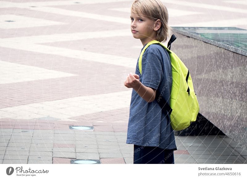 Back to school Happy boy pupil with green backpack. Generation Z Child teenage boy after school day. Education offline Cute caucasian boy enjoying studying