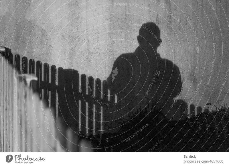 Selfie shadow cast by car headlights picket fence in foreground Shadow lattice fence B/W Shadow play Night at night portrait contast Rich in contrast Fence