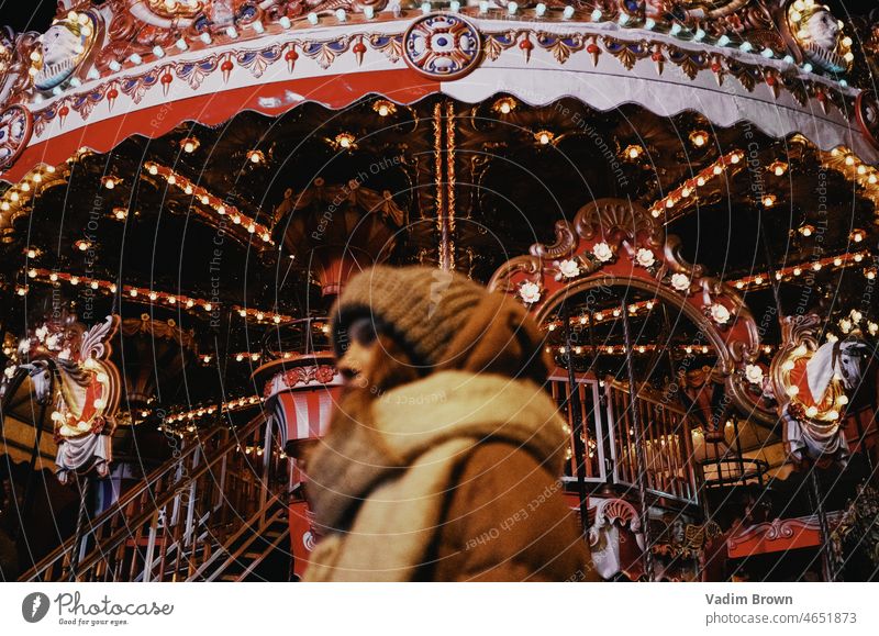 Girl and carousel Carousel Park Joy chain carousel Fairs & Carnivals Flying Light Amusement Park girl woman winter
