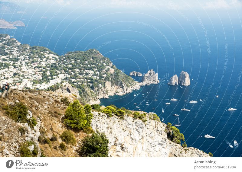 View of the Faraglioni rocks, Capri, Italy Ocean boats Water Under Blue White stones Bottom of the sea clear Transparent bank coast yacht Landscape Nature