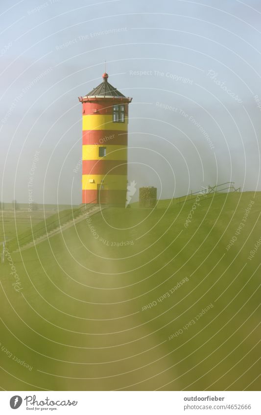 Pilsum lighthouse on sunny day Lighthouse Red Yellow Green variegated Grass Colour photo Landscape Deserted Day North Sea Tourist Attraction Copy Space top