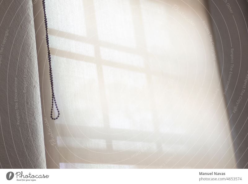 window with white curtain and chain, illuminated with soft light, background and texture. Window Curtain Drape Structures and shapes daylight Interior shot