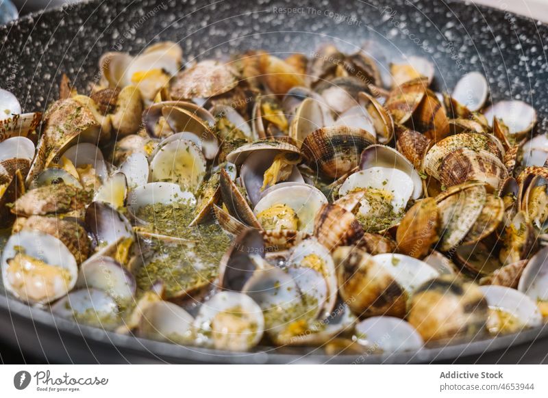 Clams in frying pan on stove clam mollusc shellfish seafood cuisine delicacy cook hot cooker meal dish tasty delicious home light fresh appetizing palatable