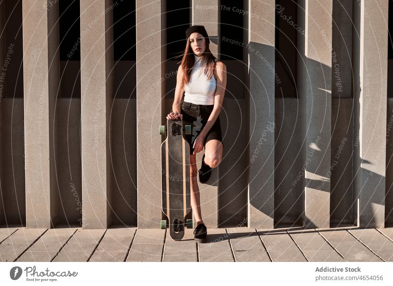 Young woman with longboard outfit appearance city urban style skater weekend street female summer young fashion hat park black white skateboard leisure stripe