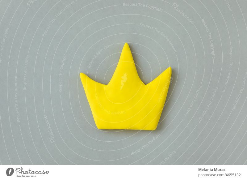 Simple 3d yellow crown symbol on gray background. Concept of win and success, top rank quality status. abstract aristocracy award best business celebration