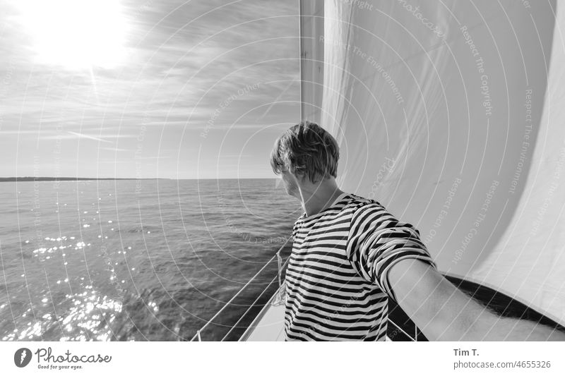 a man standing on the bow of a sailing ship Sailing b/w Black & white photo Day Exterior shot B/W B&W Baltic Sea Sailing ship Sailboat Man striped shirt Striped