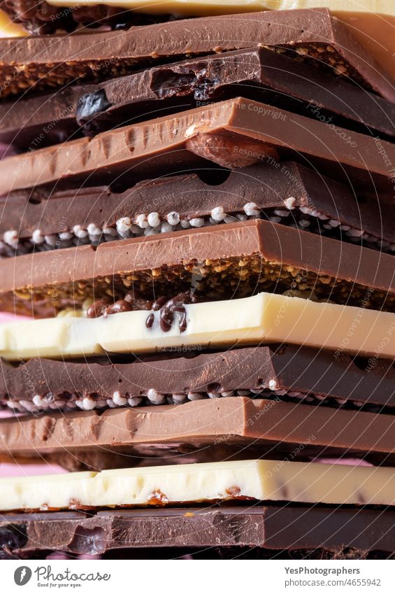 Chocolate bars in a pile, close-up. Variety of belgian chocolate. abundance assorted assortment background black brown cacao calories caramel confectionary