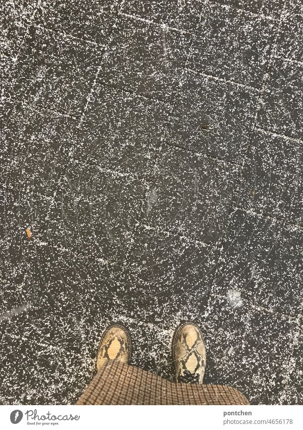 Hailstones on paving stones. A standing person. Shoes and coat visible. Fashionable, style Snow Paving stone Coat Footwear fashionable Style Hipster pattern mix