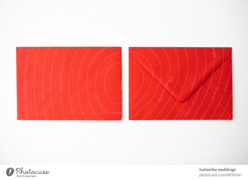 Two red paper envelopes on white background. Copy space. Isolated objects, flat lay. letter mail post blank message communication open correspondence card send