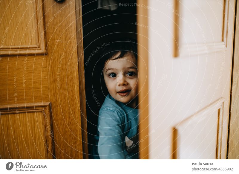 Child hiding on closet childhood 1 - 3 years Caucasian Authentic Lifestyle Colour photo Childhood memory Human being Infancy Joy Day Leisure and hobbies Hide