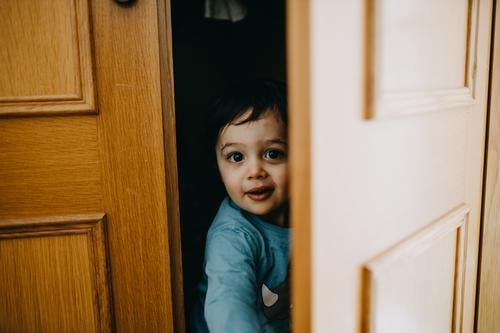 Child hiding on closet childhood 1 - 3 years Caucasian Authentic Lifestyle Colour photo Childhood memory Human being Infancy Joy Day Leisure and hobbies Hide