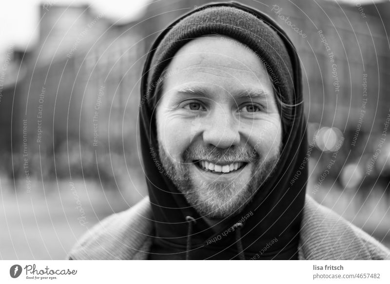 BLACK AND WHITE - CHEERFUL - LAUGHTER Black & white photo portrait Man Facial hair 30-35 years Young man Smiling Looking away Shallow depth of field