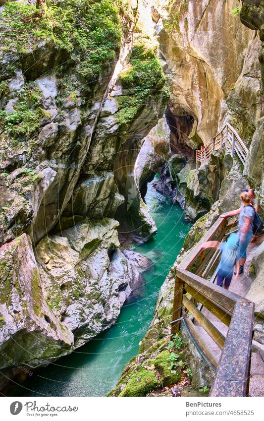 People on wooden stairs over torrent in mountain gorge. Rushing torrent Mountain gorge clammy Landscape Nature Water Waterfall Mountain torrent Whitewater