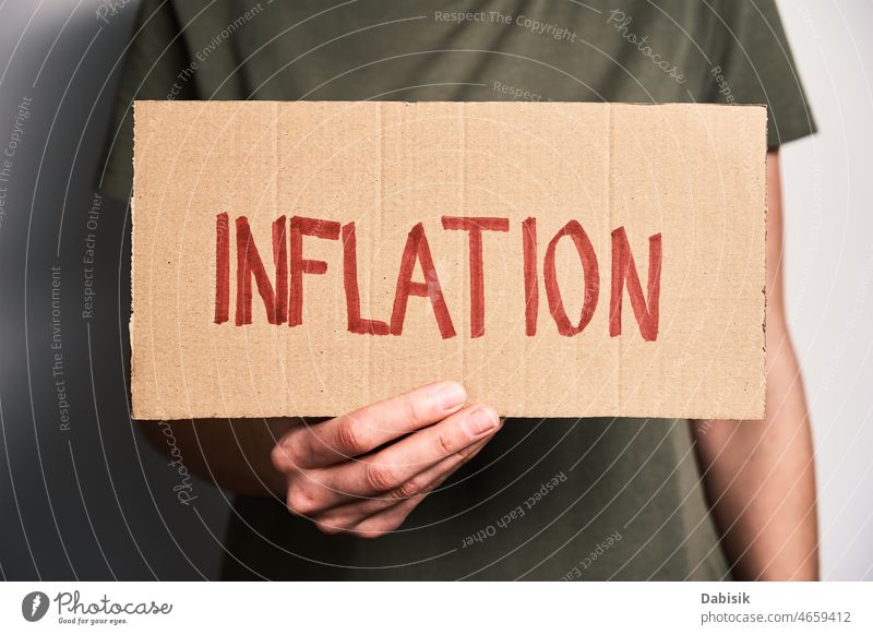 World inflation concept. Woman hold sheet with word inflation crisis finance economic risk consumer high currency us europe business dollar increase money