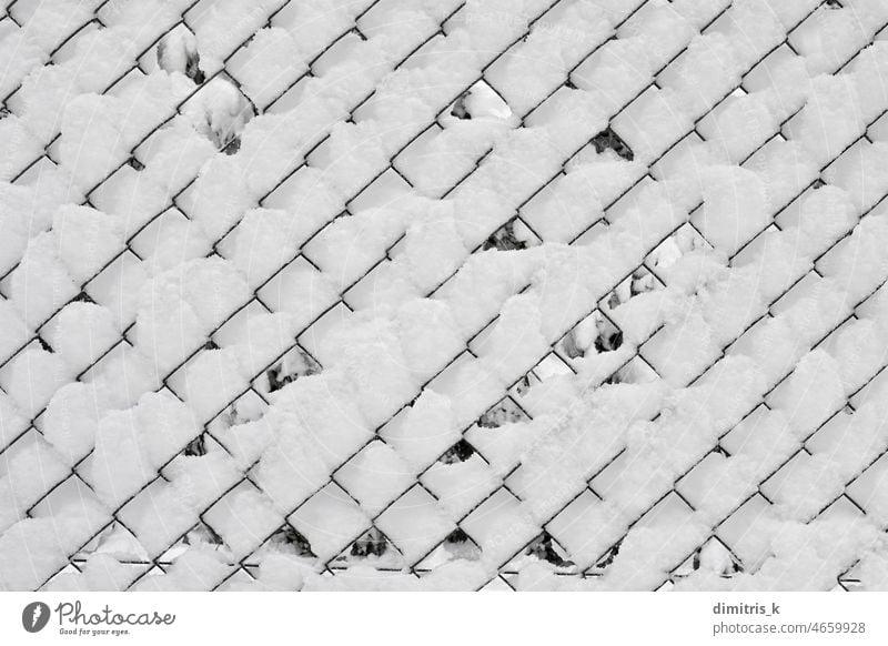 snow covered fence winter background abstract chain-link minimal white shapes cold frost wintertime lines squares holes icy temperature weather chainlink wire